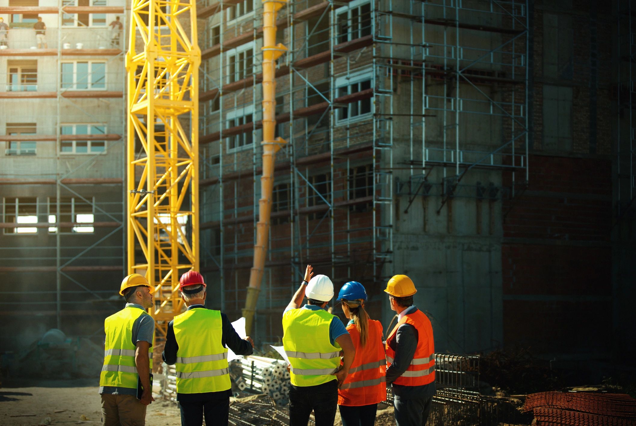 Construction team discussing work on site