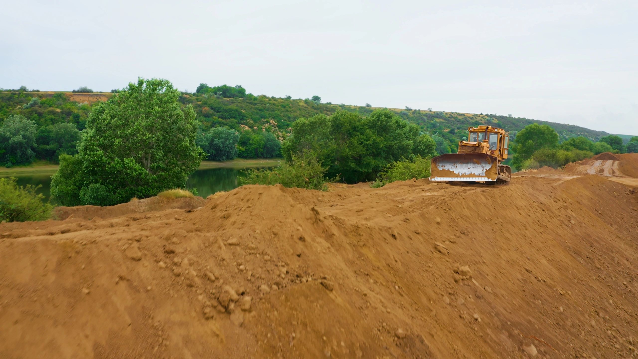 Bulldozer shaping land on a rugged outdoor job site